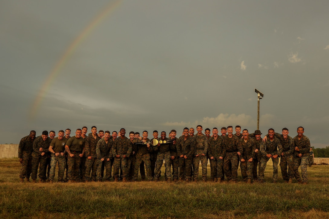 U.S. Marines with the United States Marine Corps Silent Drill Platoon, Alpha Company, Marine Barracks Washington, pose for a photo after winning the Alpha Company ground-fighting competition at Marine Corps Base Quantico, Va., Sept. 4, 2025. The competition was held as part of a field event designed to test physical readiness, teamwork, and combat effectiveness. Marines with the Silent Drill Platoon train and compete together to build cohesion and maintain the high standards expected of those serving at Marine Barracks Washington. (U.S. Marine Corps photo by Lance Cpl. Brynn L. Bouchard)