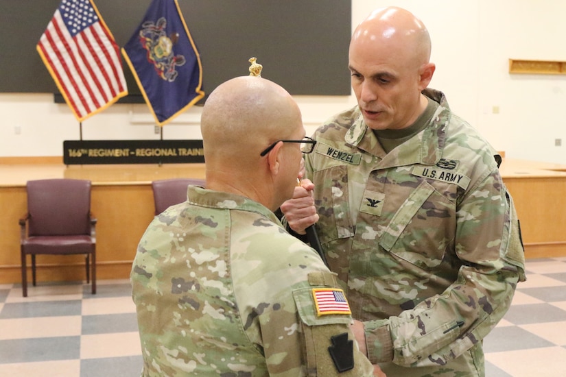 The 166th Regiment – Regional Training Institute held a change of responsibility ceremony Sept. 19, 2025 at Fort Indiantown Gap, Pa. Command Sgt. Maj. Oscar Laughman III relinquished responsibility of the regiment to Command Sgt. Maj. Charles Trofe. (U.S. Army National Guard photo by Sgt. 1st Class Shane Smith)