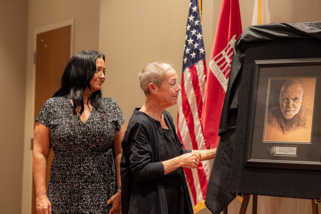 For each WES Gallery inductee, a photo is taken and added to the Gallery wall to commemorate their ERDC career. Stephens’s WES Gallery inductee photo is unique, as it is a pencil drawing of one of his final photos by Randy Kleinman, a former DAAC colleague. Dr. Stephens’ family admires the unveiling of the photo.