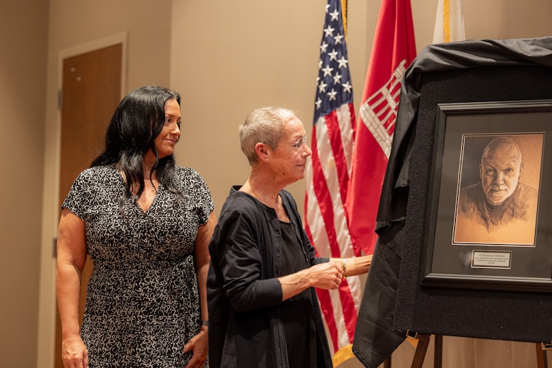 For each WES Gallery inductee, a photo is taken and added to the Gallery wall to commemorate their ERDC career. Stephens’s WES Gallery inductee photo is unique, as it is a pencil drawing of one of his final photos by Randy Kleinman, a former DAAC colleague. Dr. Stephens’ family admires the unveiling of the photo.