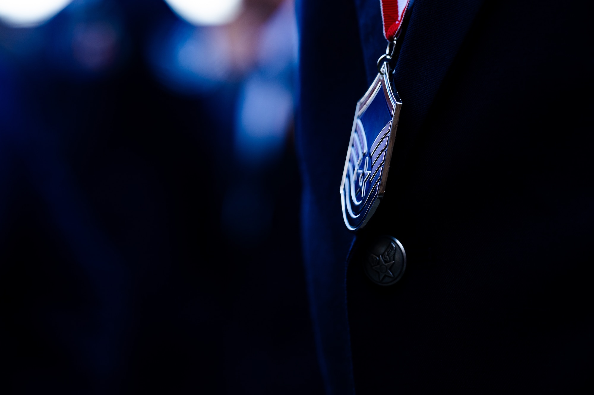 A U.S. Air Force noncommissioned officer wears a medallion during a senior NCO induction ceremony at Whiteman Air Force Base, Missouri, Sept. 19, 2025.