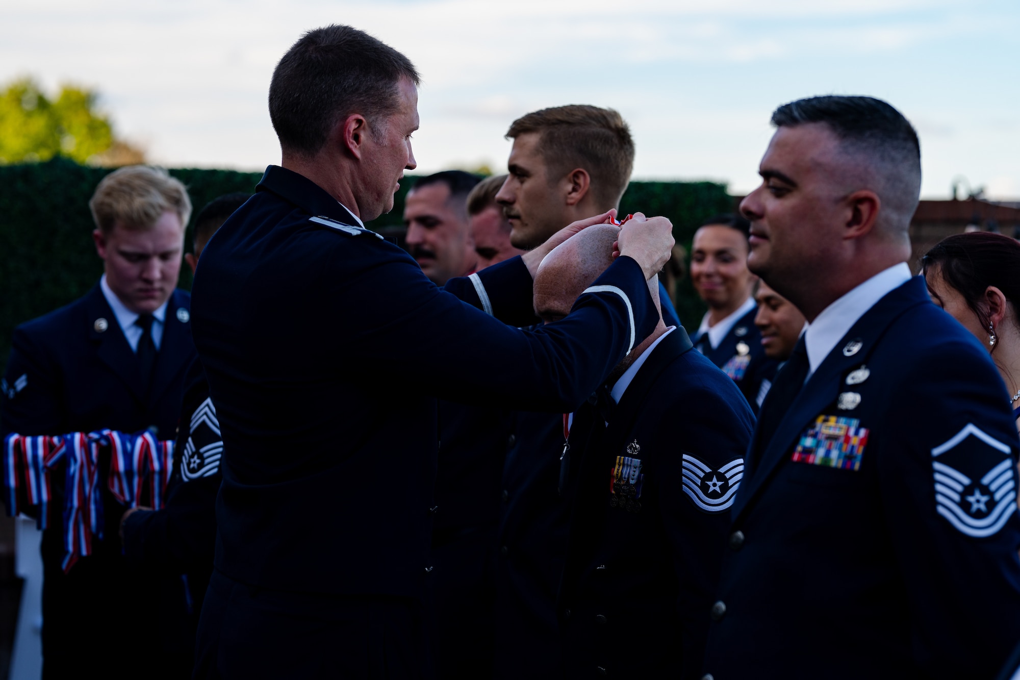 U.S. Air Force senior noncommissioned officers stand in formation to receive a medallion during a SNCO induction ceremony at Whiteman Air Force Base, Missouri, Sept. 19, 2025.