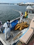 Coast Guard Incident Management Division personnel and Oil Spill Response Organization contractors conclude response efforts to secure two legacy pipe structures between piers 2 and 3 in San Juan Habor, Sept. 25, 2025.  Efforts concluded following operations by oil spill removal organization contractors to seal two legacy pipes to prevent any further discharge of oil into San Juan Harbor, followed by approximately three weeks of site monitoring with no signs of pollution in the water. (U.S. Coast Guard photo)