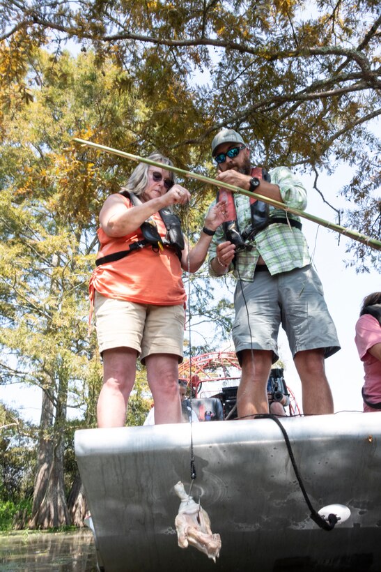 US Air Force veteran Christie Van Aken, and her guide, bait her line during the 2025 B.A. Steinhagen Veterans Alligator Hunt, sponsored by the U.S. Army Corps of Engineers' Fort Worth District, the Piney Woods Service Association, and Texas Parks and Wildlife, held at BA Steinhagen Lake, 13 Sept. 2025. There were four hunt tags given to the four veteran hunters, with three total alligators harvested.