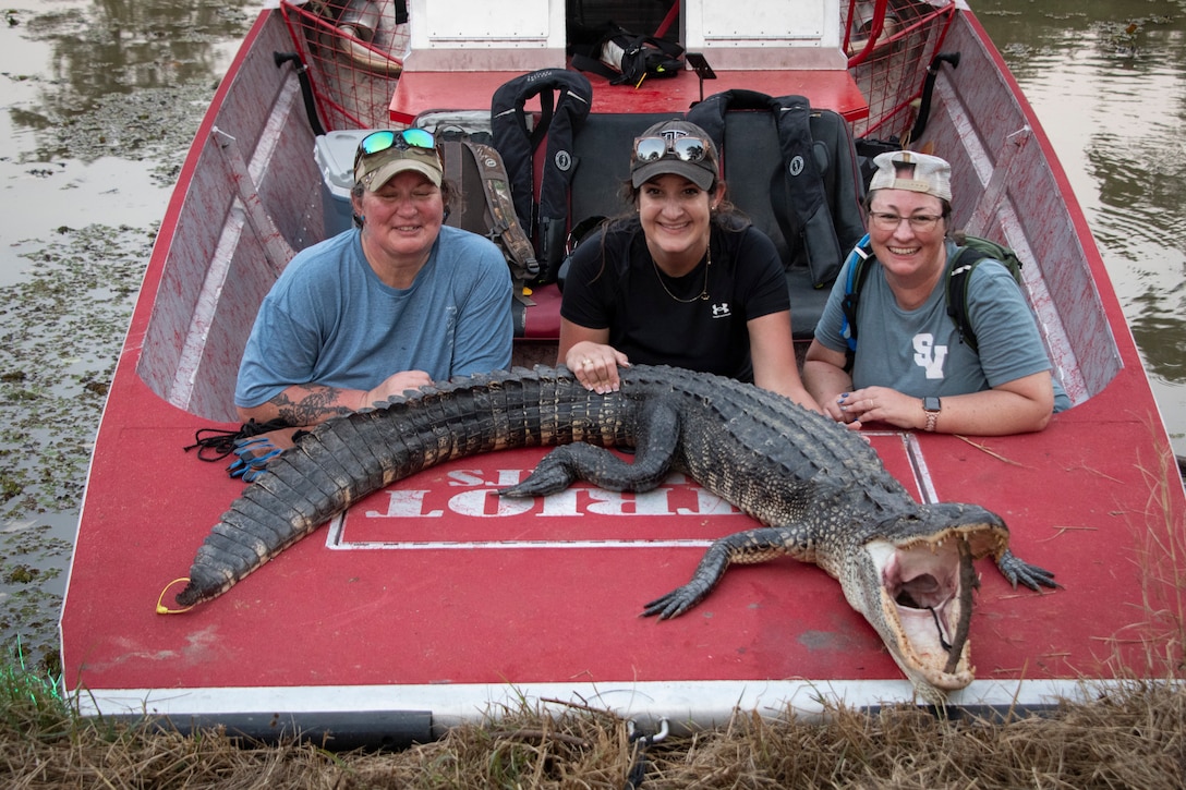Veteran hunters, Sarah Stewart, center, and Megan Moseley, right, as well as their guide, pose for photos at 2025 B.A. Steinhagen Veterans Alligator Hunt, sponsored by the U.S. Army Corps of Engineers' Fort Worth District, the Piney Woods Service Association, and Texas Parks and Wildlife, held at BA Steinhagen Lake, 13 Sept. 2025.