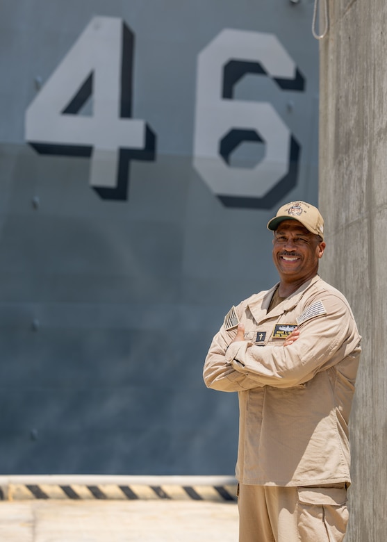 250731-N-YU102-1024 NORFOLK, Va. (July 31, 2025)—  Lt. Cmdr. Duane Hardy, a chaplain assigned to the Whidbey Island-class dock landing ship USS Tortuga (LSD 46), poses for a photograph in front of the Tortuga, July 31. This is Hardy’s second time being stationed on the Tortuga, the first being over 30 years ago as a personnelman. (U.S. Navy photo by Mass Communication Specialist 2nd Class Luke Wilson)