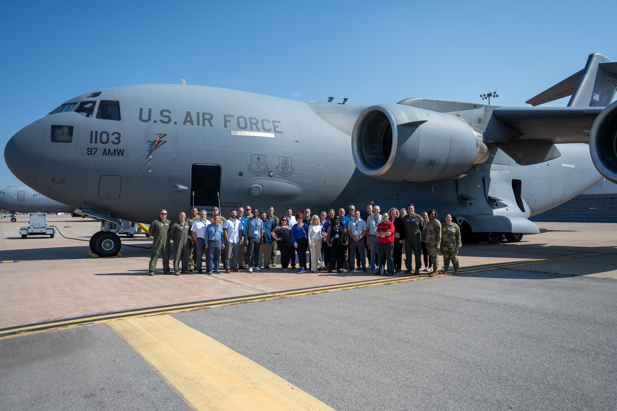 U.S. Air Force Air Education and Training Command Civic Leaders, McConnell and Altus Air Force Base (AFB) leadership pose for a group photo in front of a C-17 Globemaster III aircraft at Altus AFB, Oklahoma, Sept. 16, 2025. During the tour, civic leaders met with instructors, were given an up close look inside a C-17, and learned about the base’s impact on global mobility. (U.S. Air Force photo by Airman 1st Class Nathan Langston)