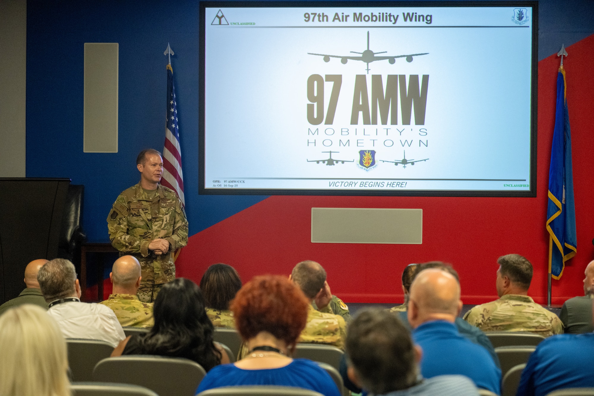 U.S. Air Force Col. Richard Kind, 97th Air Mobility Wing (AMW) commander, gives a welcoming brief to Air Education and Training Command civic leaders and McConnell Air Force Base (AFB) leadership at Altus AFB, Oklahoma, Sept. 16, 2025. The briefing consisted of Altus history, and the mission of the 97th AMW. (U.S. Air Force photo by Airman 1st Class Nathan Langston)