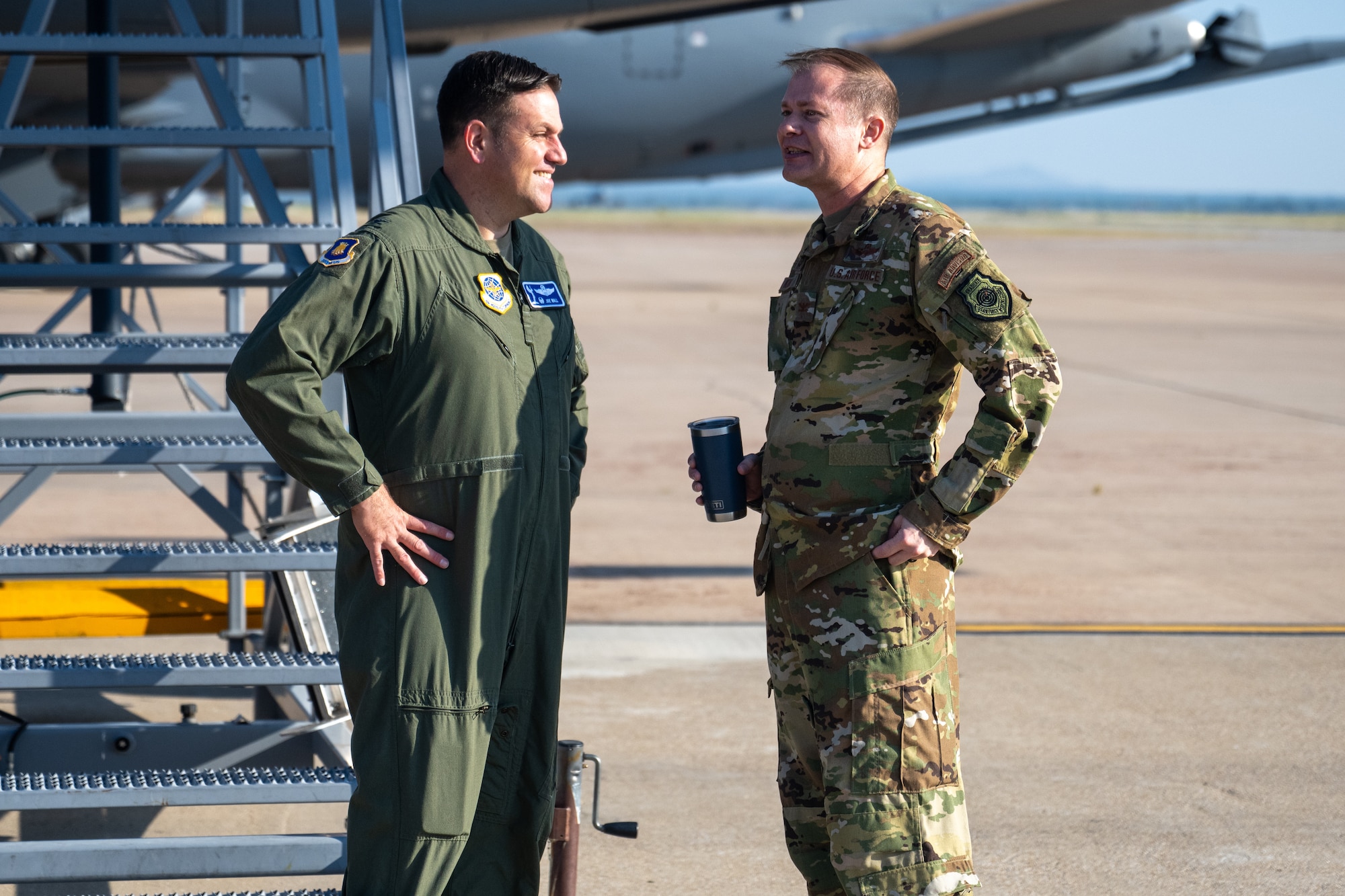 U.S. Air Force Col. Joe Wall, 22nd Air Refueling Wing commander (left), and Col. Richard Kind, 97th Air Mobility Wing commander (right), greet each other on the flightline at Altus Air Force Base, Oklahoma, Sept. 16, 2025. Wall was visiting Altus with his leadership team and Air Education and Training Command civic leaders. (U.S. Air Force photo by Airman 1st Class Nathan Langston)