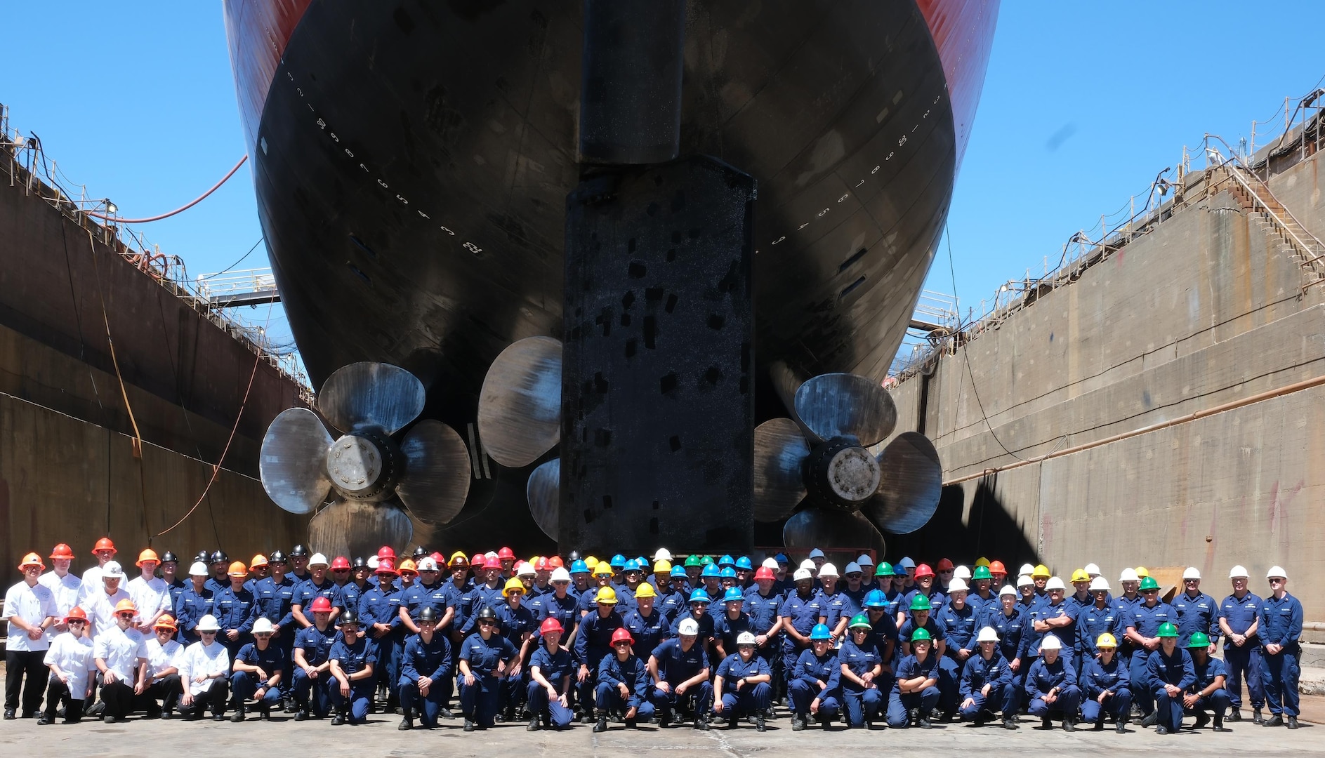 The crew of the USCGC Polar Star (WAGB 10) poses for a group photo underneath the cutter's stern while in dry dock in Vallejo, Calif., Aug. 1, 2025. The 49-year-old heavy icebreaker and crew returned to their Seattle home port Sept. 23, 2025, after 308 days away. U.S. Coast Guard courtesy photo.