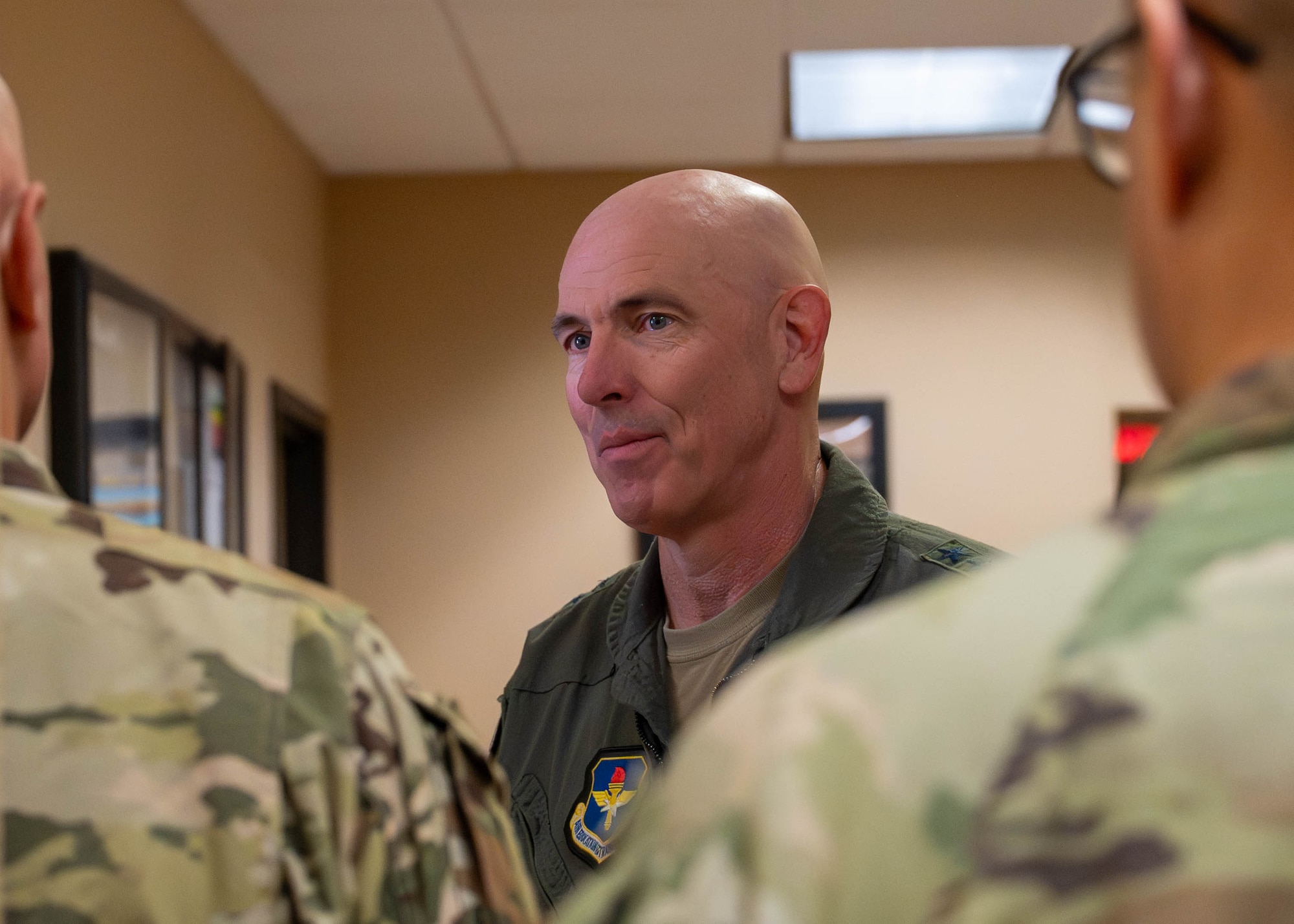 U.S. Air Force Maj. Gen. Clark Quinn, Air Education and Training Command deputy commander, speaks with Airmen in the hallway of the 607th Air Control Squadron, Sept. 16, 2025, at Luke Air Force base, Arizona.