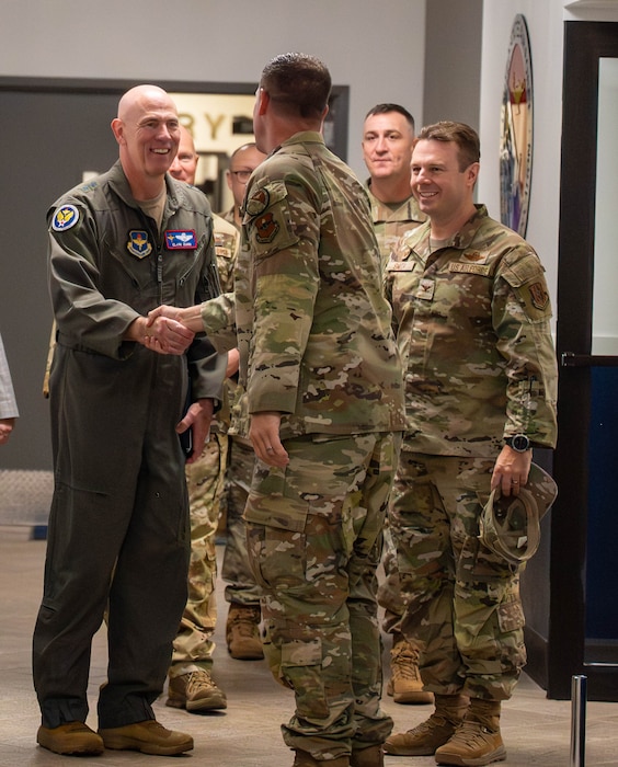 U.S. Air Force Maj. Gen. Clark Quinn (left), Air Education and Training Command deputy commander, greets Master Sgt. Justin Vaughn (center), 56th Force Support Squadron Airman Leadership School commandant, Sept. 16, 2025, at Luke Air Force Base, Arizona.   The visit showcased how ALS equips Airmen to be brilliant at the basics, ready to win tomorrow’s fight.