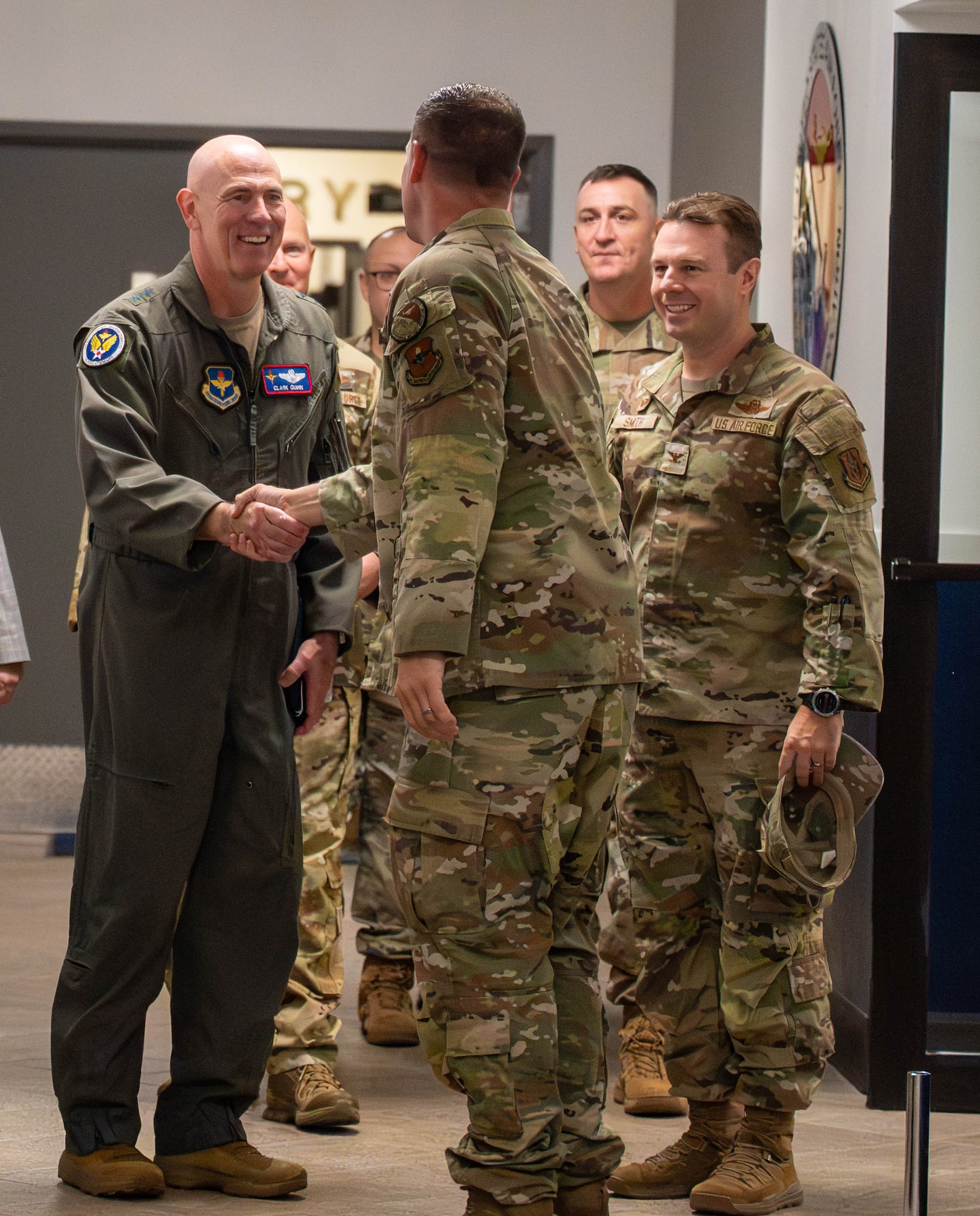 U.S. Air Force Maj. Gen. Clark Quinn (left), Air Education and Training Command deputy commander, greets Master Sgt. Justin Vaughn (center), 56th Force Support Squadron Airman Leadership School commandant, Sept. 16, 2025, at Luke Air Force Base, Arizona.   The visit showcased how ALS equips Airmen to be brilliant at the basics, ready to win tomorrow’s fight.