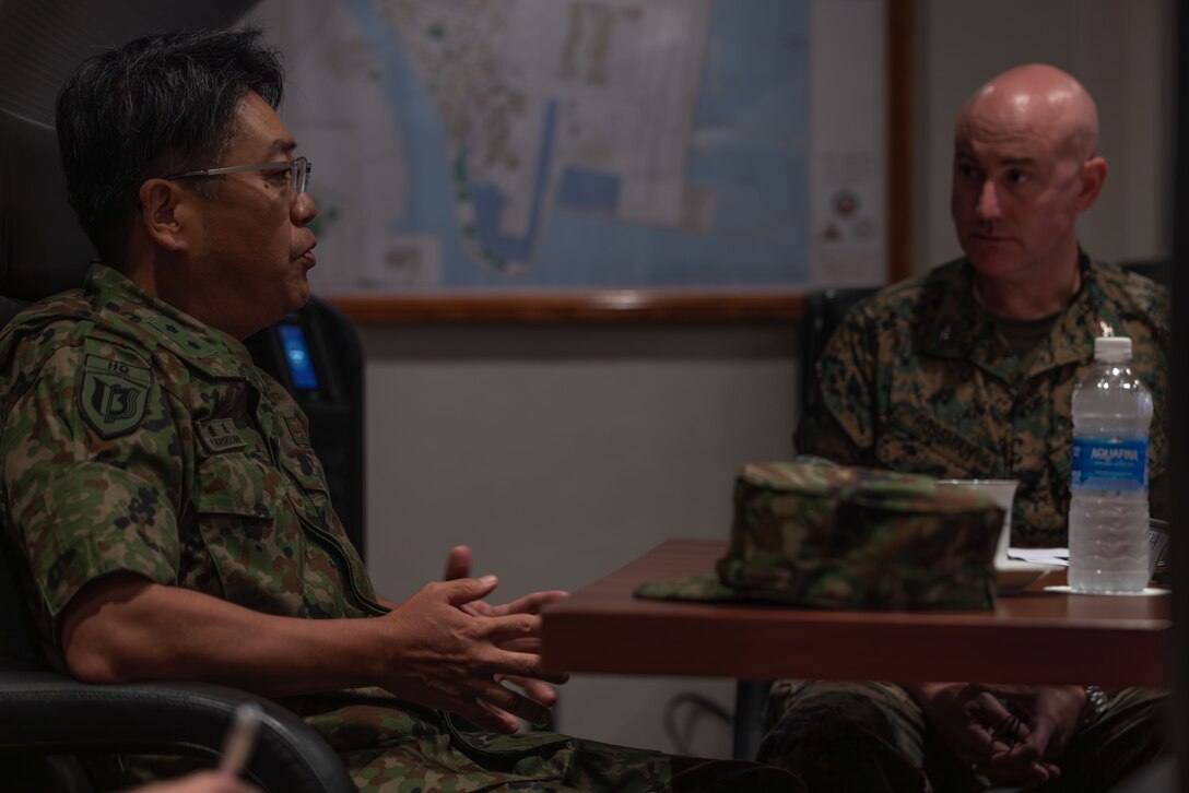 Japan Ground Self-Defense Force Major General Yoshitomo Hashizume, the commanding general of the 13th Brigade, Middle Army, speaks with U.S. Marine Corps Col. Kenneth Rossman, the commanding officer of Marine Corps Air Station Iwakuni, and a native of Pittsburgh, Pennsylvania, during a meeting at MCAS Iwakuni, Japan, Sept. 19, 2025. JGSDF Major General Hashizume and JGSDF members visited MCAS Iwakuni to gain a greater understanding of the bases’ defenses to better support MCAS Iwakuni in advance of Exercise Active Shield 26. (U.S. Marine Corps photo by Lance Cpl. Ella Cadby)