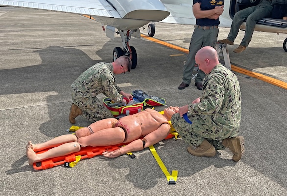 NAGASAKI, Japan (Sept. 23, 2025) – Lt. Alexander Johnson and Hospital Corpsman 3rd Class Evan Talcott, assigned to U.S. Navy Medicine Readiness and Training Command (USNMRTC) Yokosuka, transfer a simulated casualty to a C-12 Huron aircraft at Nagasaki Airport during a mass casualty drill. The patient was prepared by a U.S. Navy Medicine Readiness and Training Unit (USNMRTU) Sasebo medical crew for medical evacuation to Naval Air Facility (NAF) Atsugi. (U.S. Navy photo by Lt. Cmdr. Matthew Thomas)