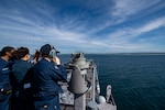 250709-N-BW367-1099 BRISBANE (July 9, 2025) Sailors assigned to the forward-deployed amphibious assault ship USS America (LHA 6) conduct sea and anchor on the ship’s forward lookout, while pulling into Brisbane, July 9. America, lead ship of the America Amphibious Ready Group, is operating in the U.S. 7th Fleet area of operations. U.S. 7th Fleet is the U.S. Navy’s largest forward-deployed numbered fleet, and routinely interacts and operates with allies and partners in preserving a free and open Indo-Pacific region. (U.S. Navy photo by Mass Communication Specialist Seaman Nicholas Douglass)