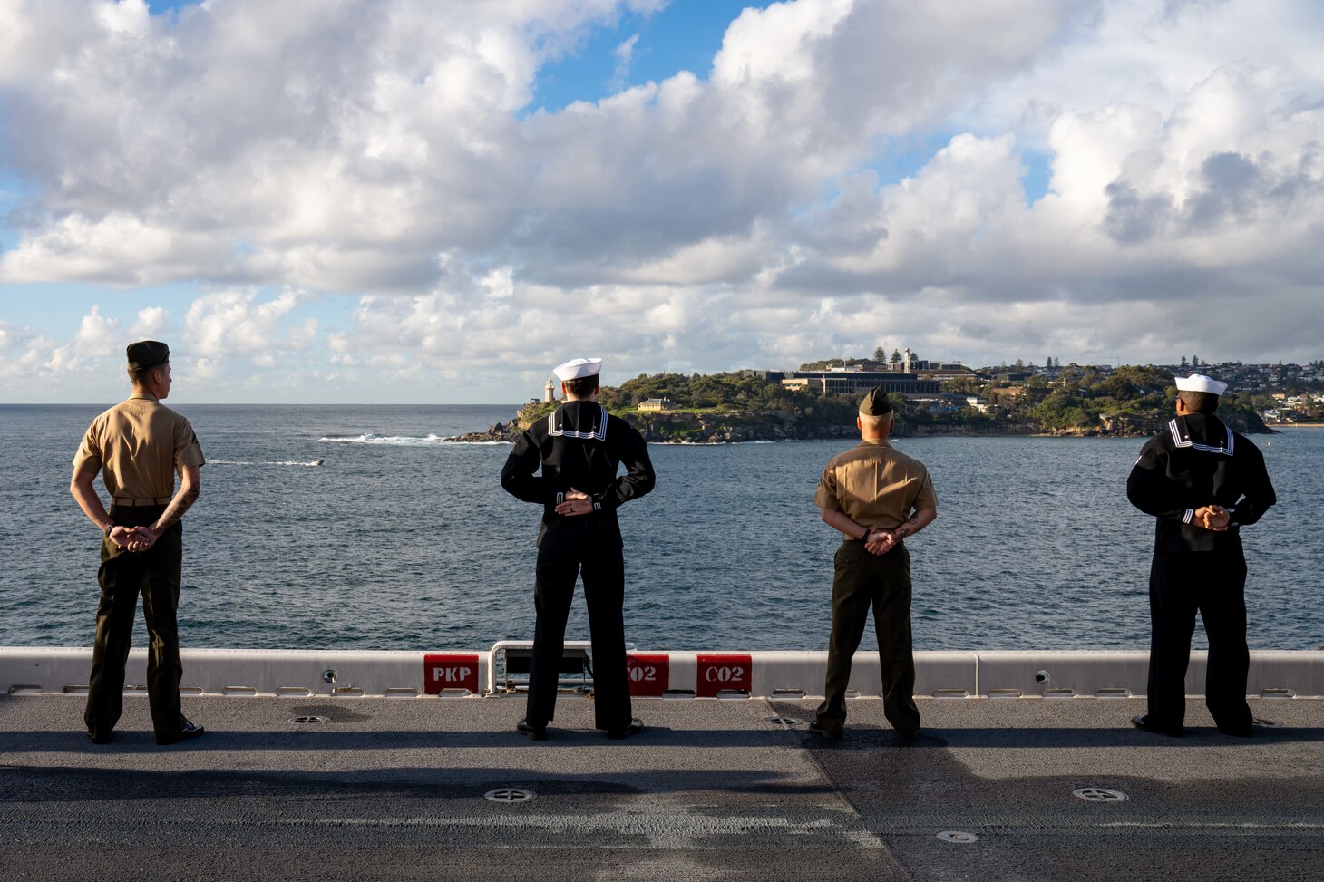 250614-N-DB724-1154 SYDNEY (June 14, 2025) Sailors assigned to the forward-deployed amphibious assault ship USS America (LHA 6), and U.S. Marines assigned to the 31st Marine Expeditionary Unit (MEU), man the rails on the ship’s flight deck, while arriving in Sydney, June 14. America, lead ship of the America Amphibious Ready Group, is operating in the U.S. 7th Fleet area of operations. U.S. 7th Fleet is the U.S. Navy’s largest forward-deployed numbered fleet, and routinely interacts and operates with allies and partners in preserving a free and open Indo-Pacific region. (U.S. Navy photo by Mass Communication Specialist 1st Class Jomark A. Almazan)