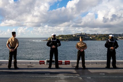 250614-N-DB724-1154 SYDNEY (June 14, 2025) Sailors assigned to the forward-deployed amphibious assault ship USS America (LHA 6), and U.S. Marines assigned to the 31st Marine Expeditionary Unit (MEU), man the rails on the ship’s flight deck, while arriving in Sydney, June 14. America, lead ship of the America Amphibious Ready Group, is operating in the U.S. 7th Fleet area of operations. U.S. 7th Fleet is the U.S. Navy’s largest forward-deployed numbered fleet, and routinely interacts and operates with allies and partners in preserving a free and open Indo-Pacific region. (U.S. Navy photo by Mass Communication Specialist 1st Class Jomark A. Almazan)
