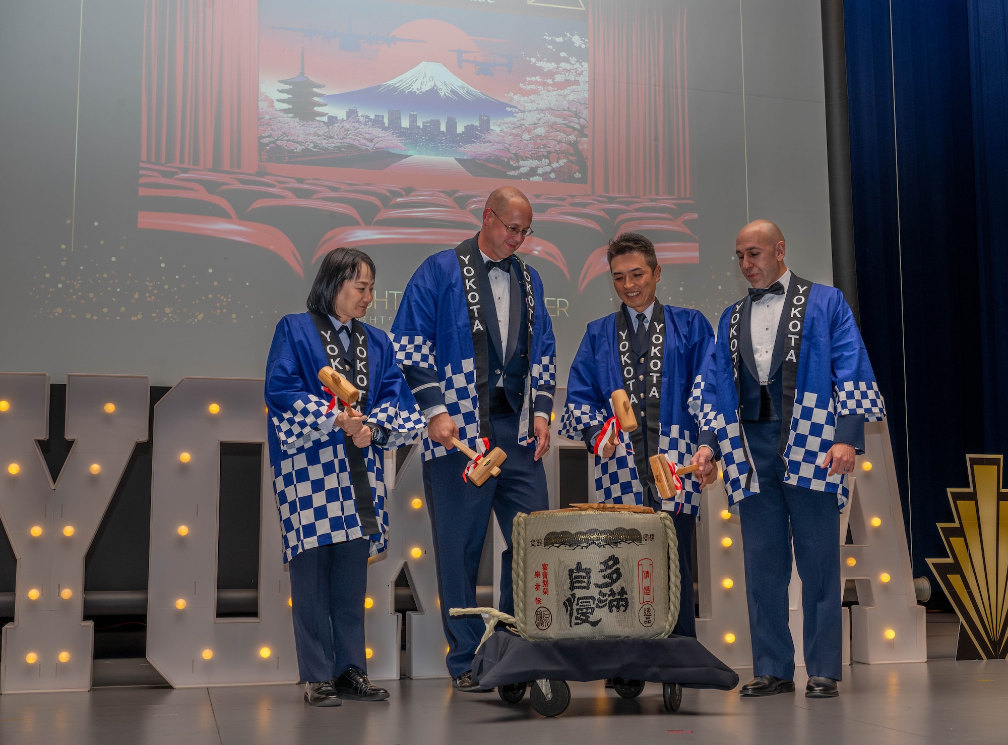 Japan Air Self-Defense Force and 374th Airlift Wing leadership break open a barrel of celebratory Japanese sake.