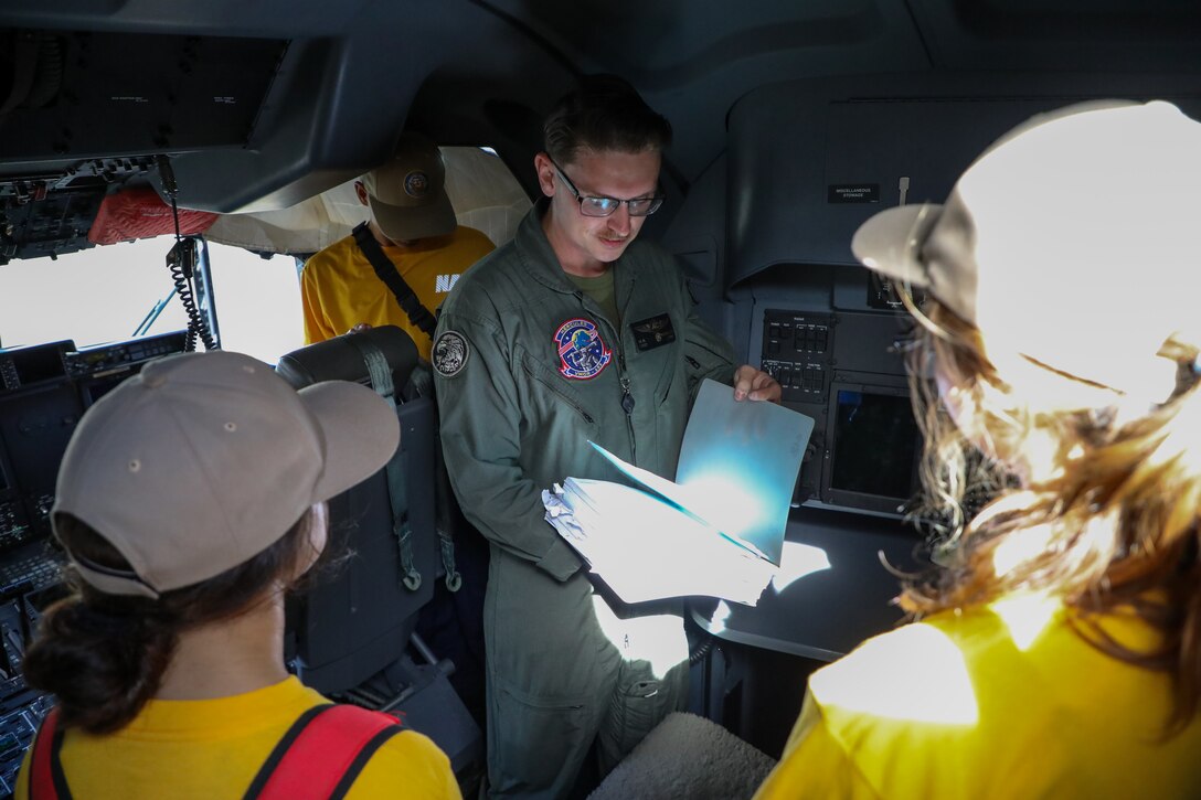 U.S. Marine Corps Staff Sgt. William Frizzell III, a Loadmaster, with Marine Aerial Refueler Transport Squadron 153, Marine Aircraft Group 24, 1st Marine Aircraft Wing, provides information to Naval Junior ROTC cadets of Kalaheo High School during a static display presentation at Marine Corps Air Station Kaneohe Bay, Hawaii, Sept. 12, 2025.  The visit gave the NJROTC cadets a comprehensive look at how a military aviation unit operates through the various roles and responsibilities from mechanical maintenance to flight operations. (U.S. Marine Corps photo by Staff Sgt. Heather Atherton)