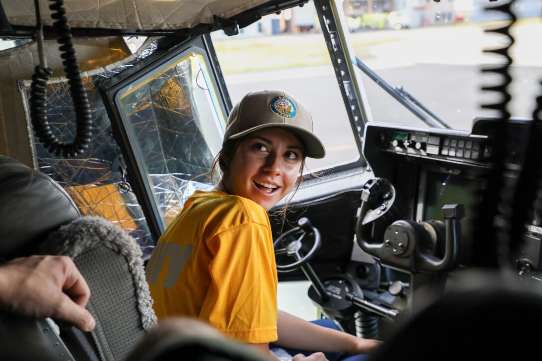 A Naval Junior ROTC cadet of Kalaheo High School explores the cockpit of a KC-130J Super Hercules during a static display presentation at Marine Corps Air Station Kaneohe Bay, Hawaii, Sept. 12, 2025.  The visit gave the NJROTC cadets a comprehensive look at how a military aviation unit operates through the various roles and responsibilities from mechanical maintenance to flight operations. (U.S. Marine Corps photo by Staff Sgt. Heather Atherton)