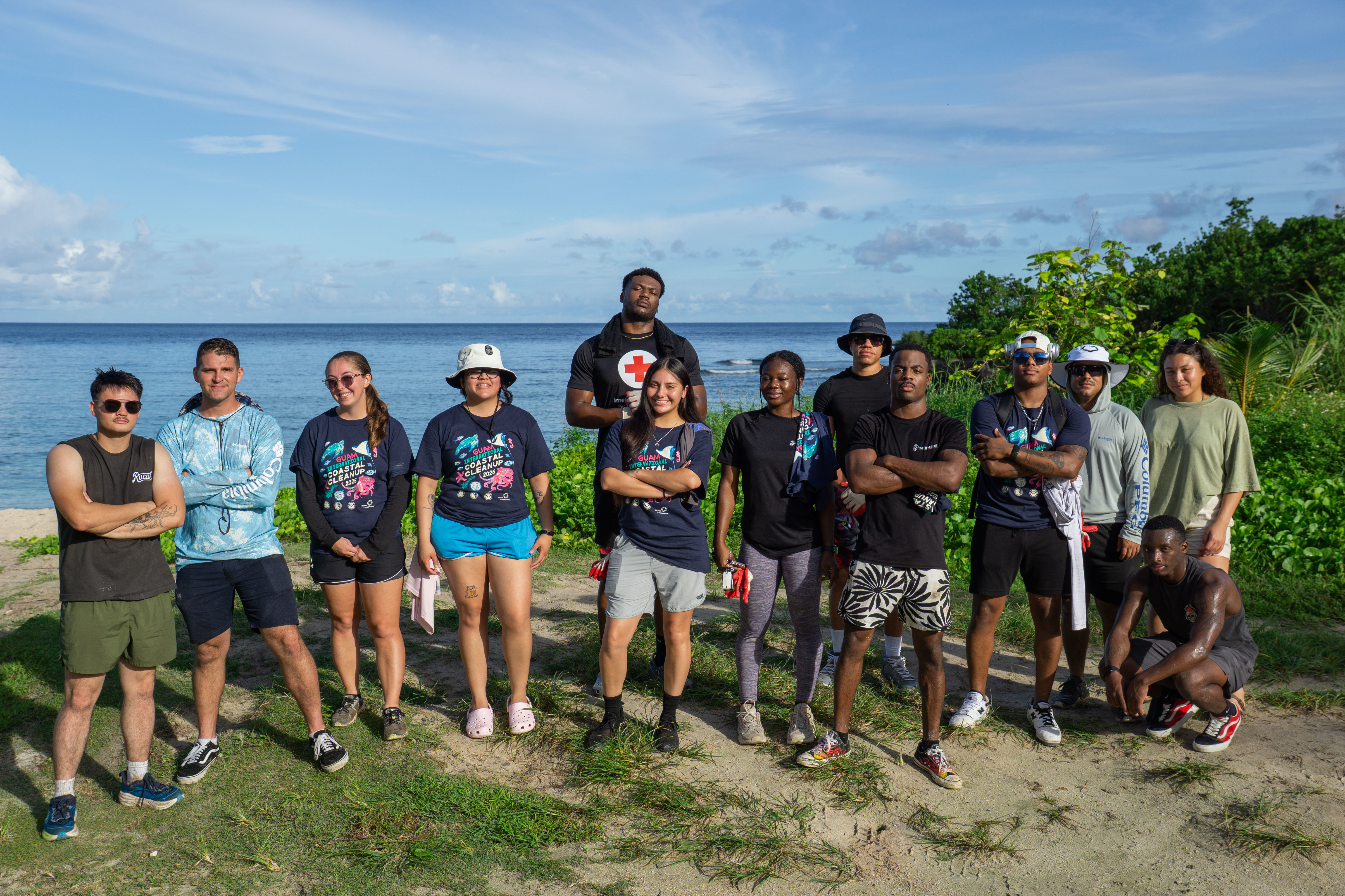 U.S. Marines with Marine Corps Base Camp Blaz, and Combat Logistics Company 34, Combat Logistics Regiment 37, 3rd Marine Logistics Group, pose for an event completion photo during the annual Coastal Clean Up at Tanguisson Beach, Dededo, Guam, Sept. 20, 2025. Guam based Marines, family members, and civilian counterparts participated in the annual island wide Coastal Clean Up facilitated by the Guam Coastal Management Program – collecting an estimated 800lbs of waste. (U.S. Marine Corps photo by Chelsey Suarez-Pierce)