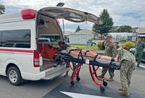 ATSUGI, Japan (Sept. 23, 2025) – Medical personnel from U.S. Navy Medicine Readiness and Training Unit (USNMRTU) Atsugi load a simulated casualty into an ambulance for transport to U.S. Naval Hospital Yokosuka during a mass casualty drill. The transfer followed a medical evacuation flight from Nagasaki to Naval Air Facility Atsugi, testing coordination and patient movement procedures across multiple Navy medical commands in Japan. (U.S. Navy photo by Lt. Cmdr. Matthew Thomas)