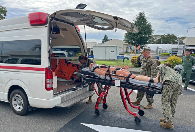 ATSUGI, Japan (Sept. 23, 2025) – Medical personnel from U.S. Navy Medicine Readiness and Training Unit (USNMRTU) Atsugi load a simulated casualty into an ambulance for transport to U.S. Naval Hospital Yokosuka during a mass casualty drill. The transfer followed a medical evacuation flight from Nagasaki to Naval Air Facility Atsugi, testing coordination and patient movement procedures across multiple Navy medical commands in Japan. (U.S. Navy photo by Lt. Cmdr. Matthew Thomas)