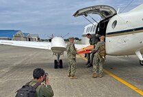 ATSUGI, Japan (Sept. 23, 2025) – – Lt. Alexander Johnson and Hospital Corpsman 3rd Class Evan Talcott, assigned to U.S. Navy Medicine Readiness and Training Command (USNMRTC) Yokosuka offloaded a simulated casualty is from a C-12 Huron aircraft at Naval Air Facility (NAF) Atsugi during a mass casualty drill. The patient was transported by a U.S. Navy Medicine Readiness and Training Unit (USNMRTU) Atsugi ambulance to U.S. Naval Hospital Yokosuka for further treatment, completing the final phase of the multi-command evacuation scenario. (U.S. Navy photo by Lt. Cmdr. Matthew Thomas)