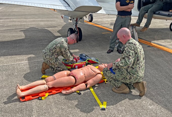NAGASAKI, Japan (Sept. 23, 2025) – Lt. Alexander Johnson and Hospital Corpsman 3rd Class Evan Talcott, assigned to U.S. Navy Medicine Readiness and Training Command (USNMRTC) Yokosuka, transfer a simulated casualty to a C-12 Huron aircraft at Nagasaki Airport during a mass casualty drill. The patient was prepared by a U.S. Navy Medicine Readiness and Training Unit (USNMRTU) Sasebo medical crew for medical evacuation to Naval Air Facility (NAF) Atsugi. (U.S. Navy photo by Lt. Cmdr. Matthew Thomas)