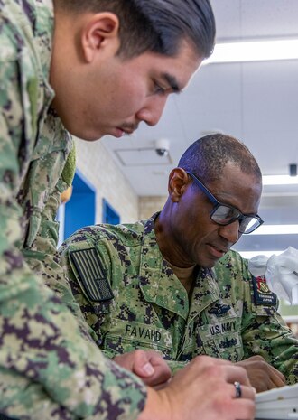 YOKOSUKA, Japan (Sept. 23, 2025) – Cmdr. Stanley Favard, acting commanding officer of U.S. Navy Medicine Readiness and Training Command (USNMRTC) Yokosuka, announces the start of a mass casualty drill over the hospital’s 1MC system. The exercise tested the command’s ability to triage, treat and transport multiple simulated patients during a crisis. (U.S. Navy photo by Daniel Taylor/USNMRTC Yokosuka Public Affairs)