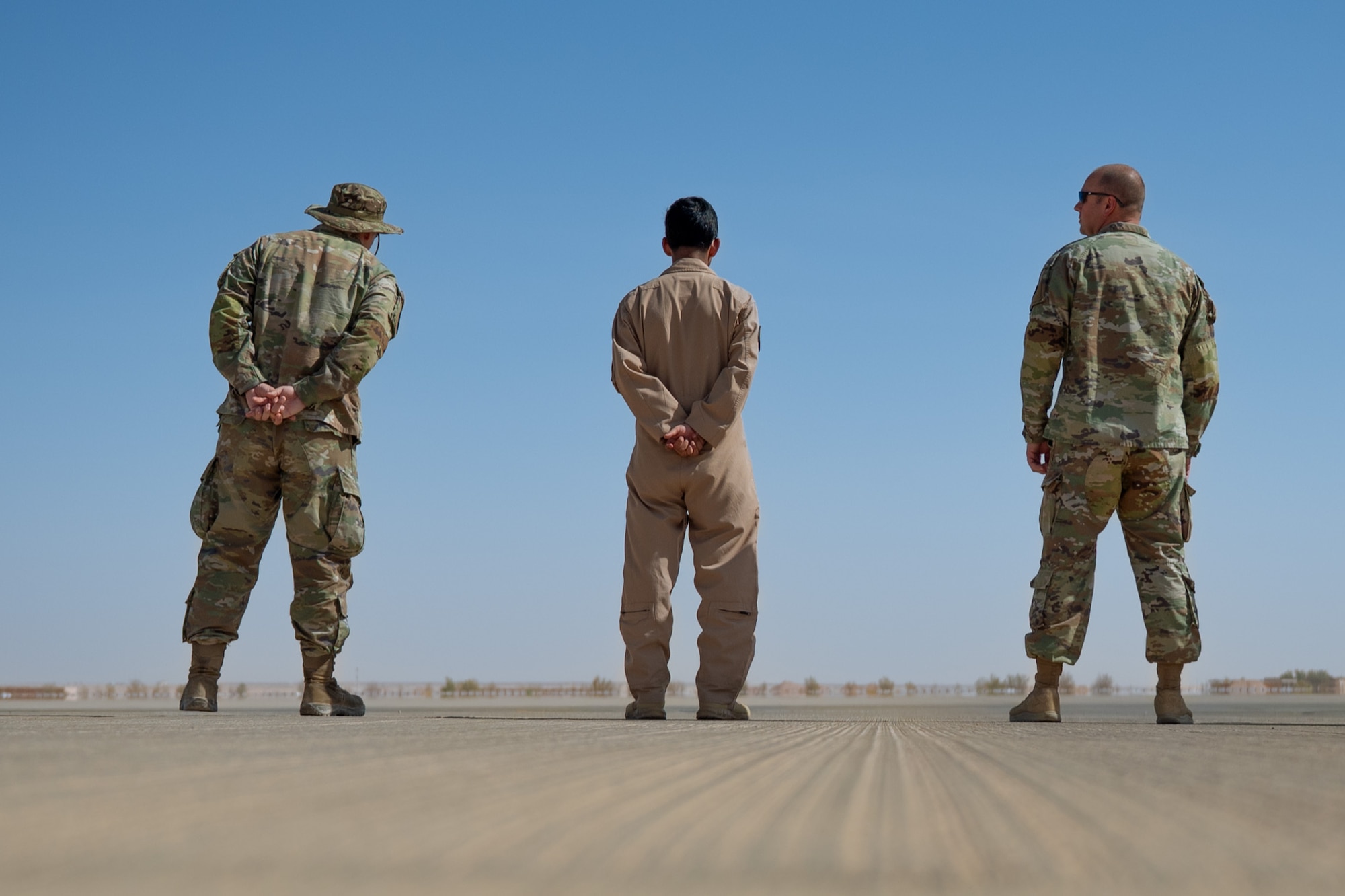 USAF and RSAF service members stand on a flghtline