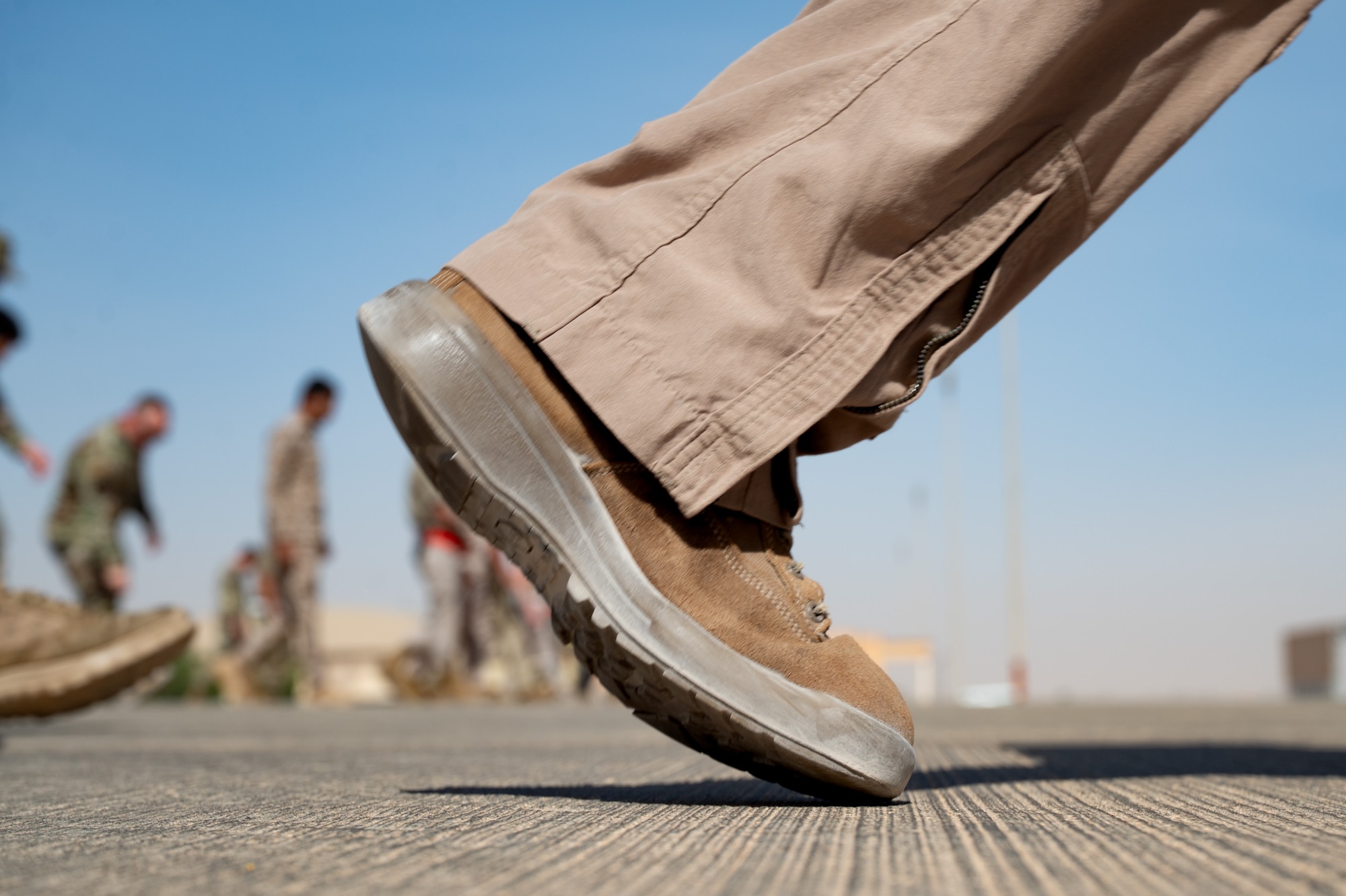 An Airman steps across a flightline