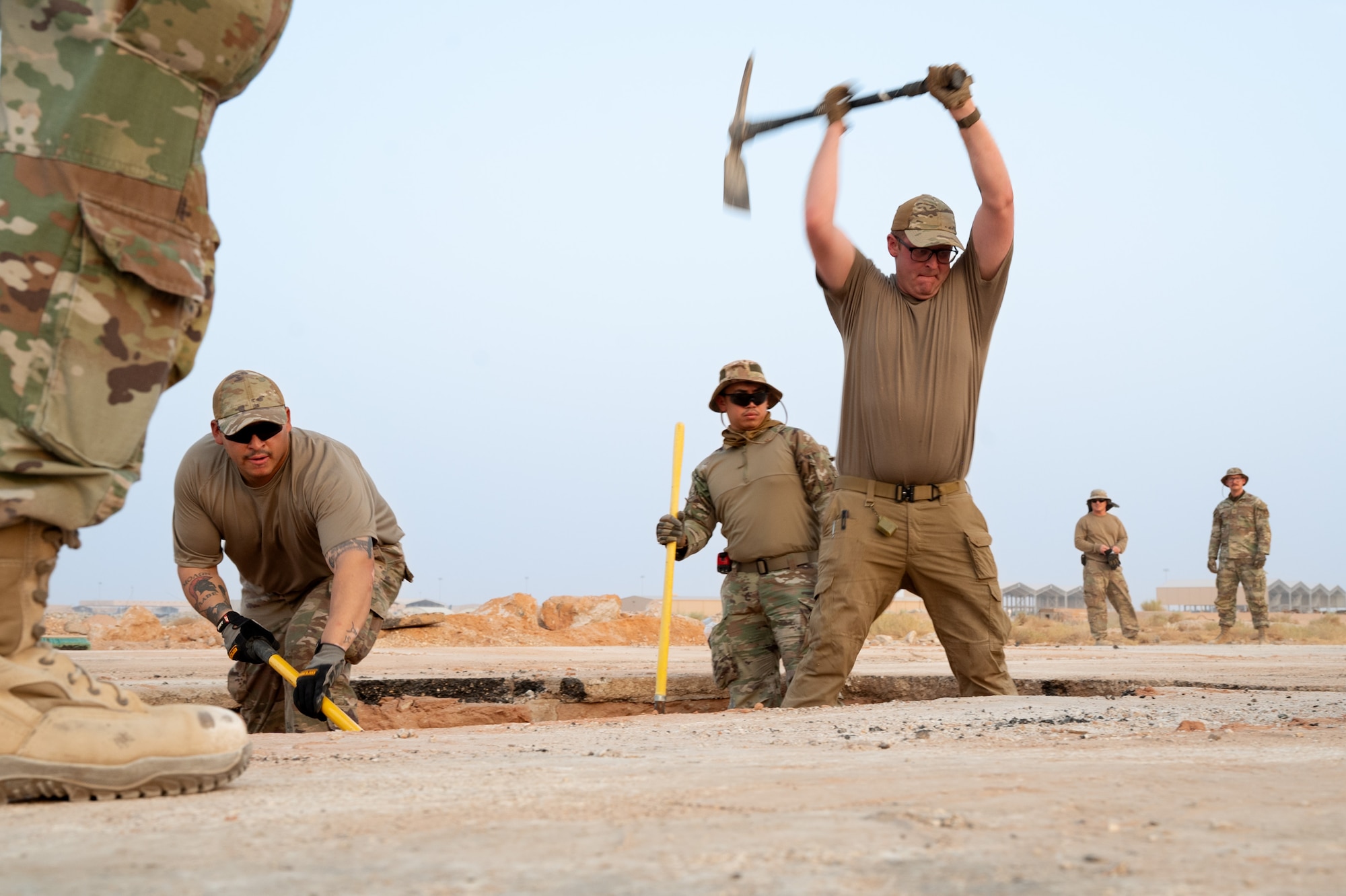 USAF Airman swings pickaxe