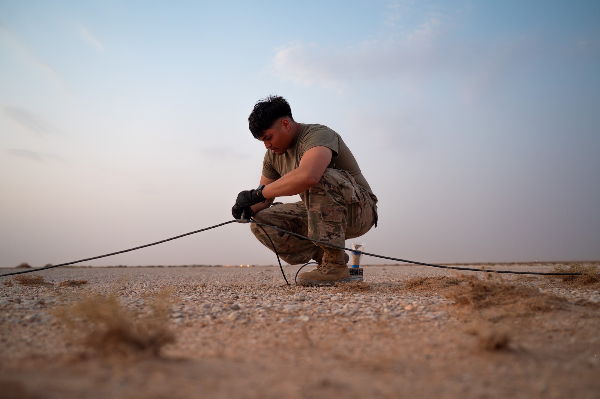 USAF Airman plugs in an expeditionary airfield light