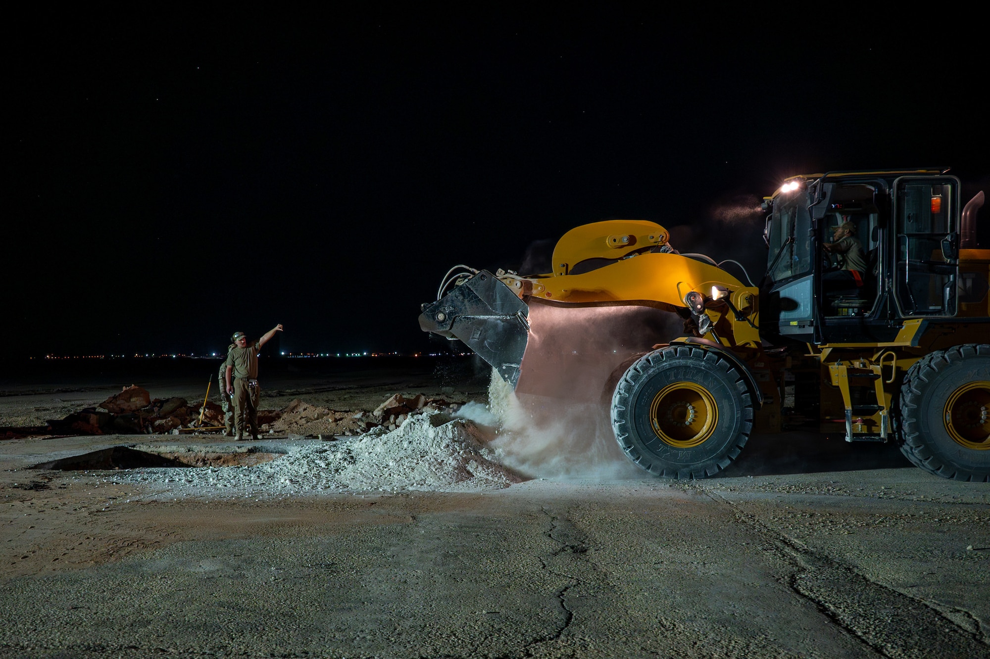 USAF Airman marshalls a loader