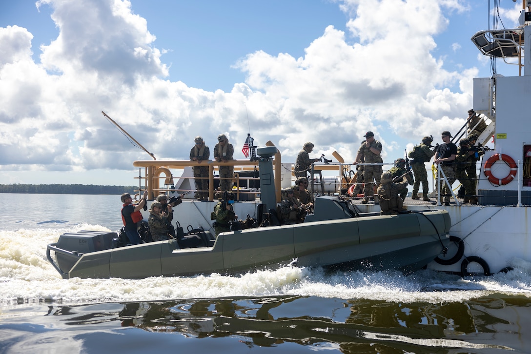 U.S. Marines with 4th Assault Amphibian Battalion, 4th Marine Division, and marines with Infantería de Marina Colombiana (Colombian marine corps) board a moving ship while on Multi Mission Reconnaissance Craft-A littoral crafts, to conduct visit, board, search and seizure training during exercise UNITAS 2025 Marine Corps Air Station Cherry Point, North Carolina, Sept. 23, 2025. UNITAS, which is Latin for “unity,” was conceived in 1959 and has taken place annually since first conducted in 1960. This year marks the 66th iteration of the world’s longest running annual multinational maritime exercise. (U.S. Marine Corps photo by Lance Cpl. Payton Goodrich)