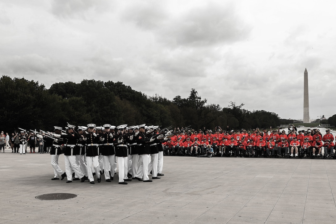 U.S. Marines with the United States Marine Corps Silent Drill Platoon, Alpha Company, Marine Barracks Washington, conduct the “bursting bomb” drill sequence at the Lincoln Memorial in Washington, D.C., Sept. 16, 2025. The Silent Drill Platoon performs ceremonial drill movements without verbal commands, showcasing precision and discipline in support of Marine Corps traditions. The ceremony was part of an honor flight event recognizing Vietnam veterans from all military branches for their service and sacrifice. (U.S. Marine Corps photo illustration by Lance Cpl. Brynn L. Bouchard)