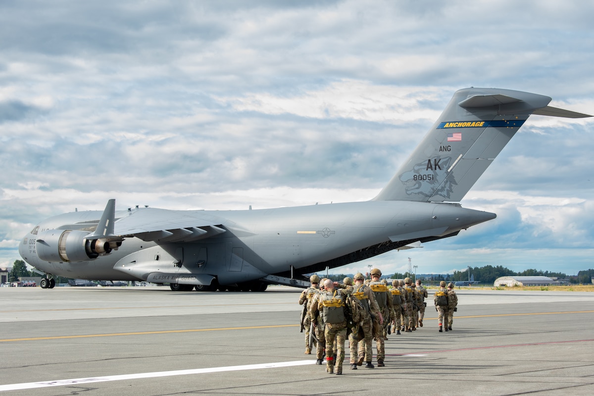 Airmen assigned to the 1st Air Support Operations Group from Joint Base Lewis-McCord, Wash., load onto a C-17 Globemaster III assigned to the 176th Wing during joint airborne operations at Joint Base Elmendorf-Richardson, Alaska, Aug. 26, 2025. The joint operation brought together various units supporting the Indo-Pacific mission in complex environments. (U.S. Air Force photo by Airman 1st Class Tala Hunt)