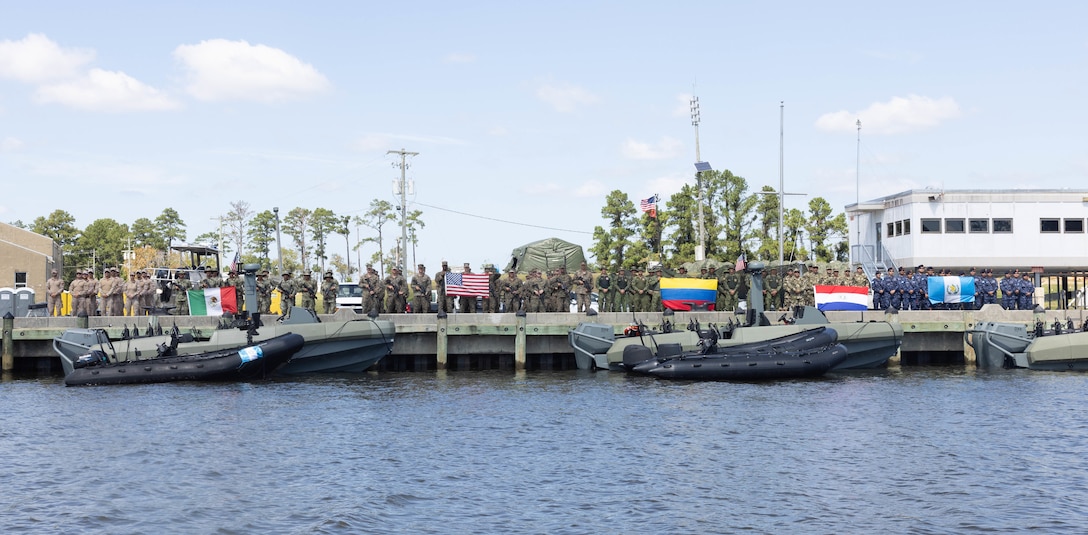 U.S. Marines with 4th Assault Amphibian Battalion, 4th Marine Division stand with marines from Infantería de Marina, Cuerpo de Infantería de Marina (Spanish marine corps), Cuerpo de Infantería de Marina (Mexican marine corps), Infantería de Marina Colombiana (Columbian marine corps), Comando de Infantería de Marina (Paraguayan marines) and Brigada de Infantería de Marina (marine infantry brigade) of Guatemala, during exercise UNITAS 2025 at Marine Corps Air Station Cherry Point, North Carolina, Sept. 21, 2025. UNITAS is a comprehensive multinational exercise that aims to strengthen interoperability, enhance operational readiness, and foster enduring partnerships among the participating nations. Marine Corps Air Station Cherry Point's Navy Boat Docks can facilitate a rapid launch into the Neuse River with access to North Carolina's Intracoastal Waterways, which supports the UNITAS objective for training forces in joint maritime operations to enhance tactical proficiency and increase interoperability. (U.S. Marine Corps photo by Cpl. Andre Marshall)