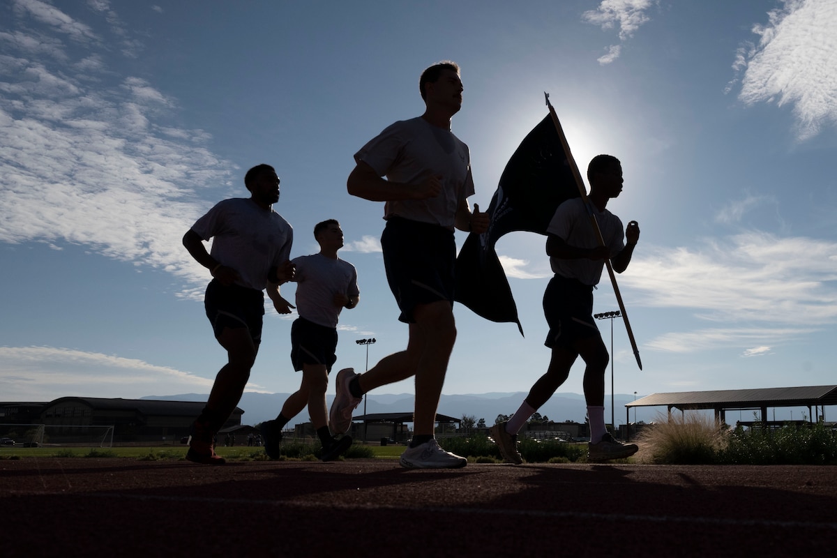 Airmen assigned to the 49th Wing participate in a 24-hour run in honor of POW/MIA Remembrance Week at Holloman Air Force Base, N.M., Sept. 18, 2025. POW/MIA Remembrance Week is held every September to honor more than 80,000 Americans that have been held as prisoners of war or missing in action. (U.S. Air Force photo by Airman 1st Class Elijah Strickland)