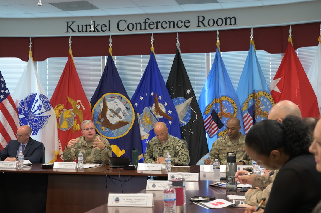 People have a meeting in a conference room.