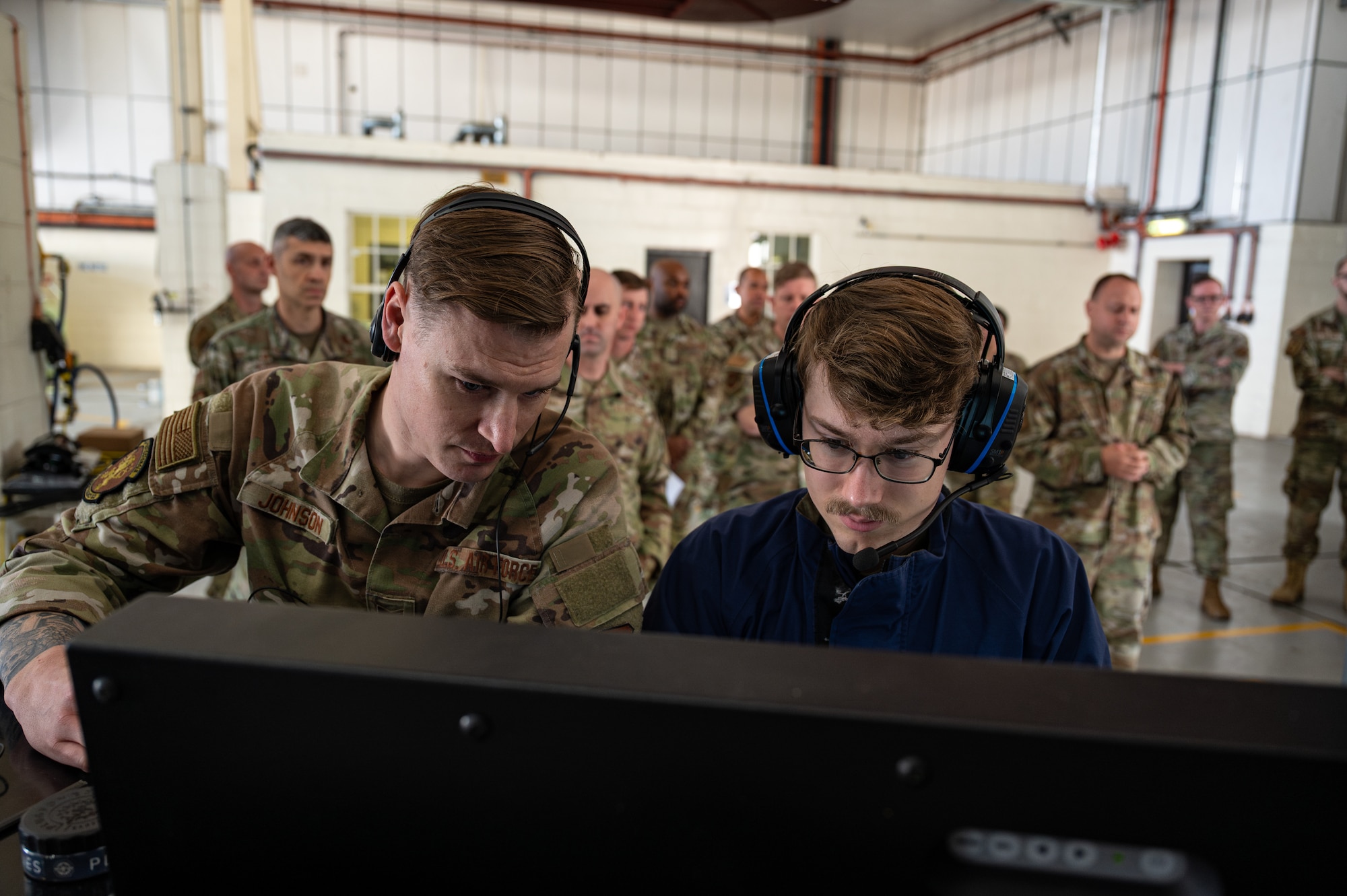 From left, U.S. Air Force Tech. Sgt. Jubal Johnson and Senior Airman Hunter Holland, both with the 100th Maintenance Squadron, monitor the Integrated Respirator Information System during a demonstration at RAF Mildenhall, England, Sept. 2, 2025.