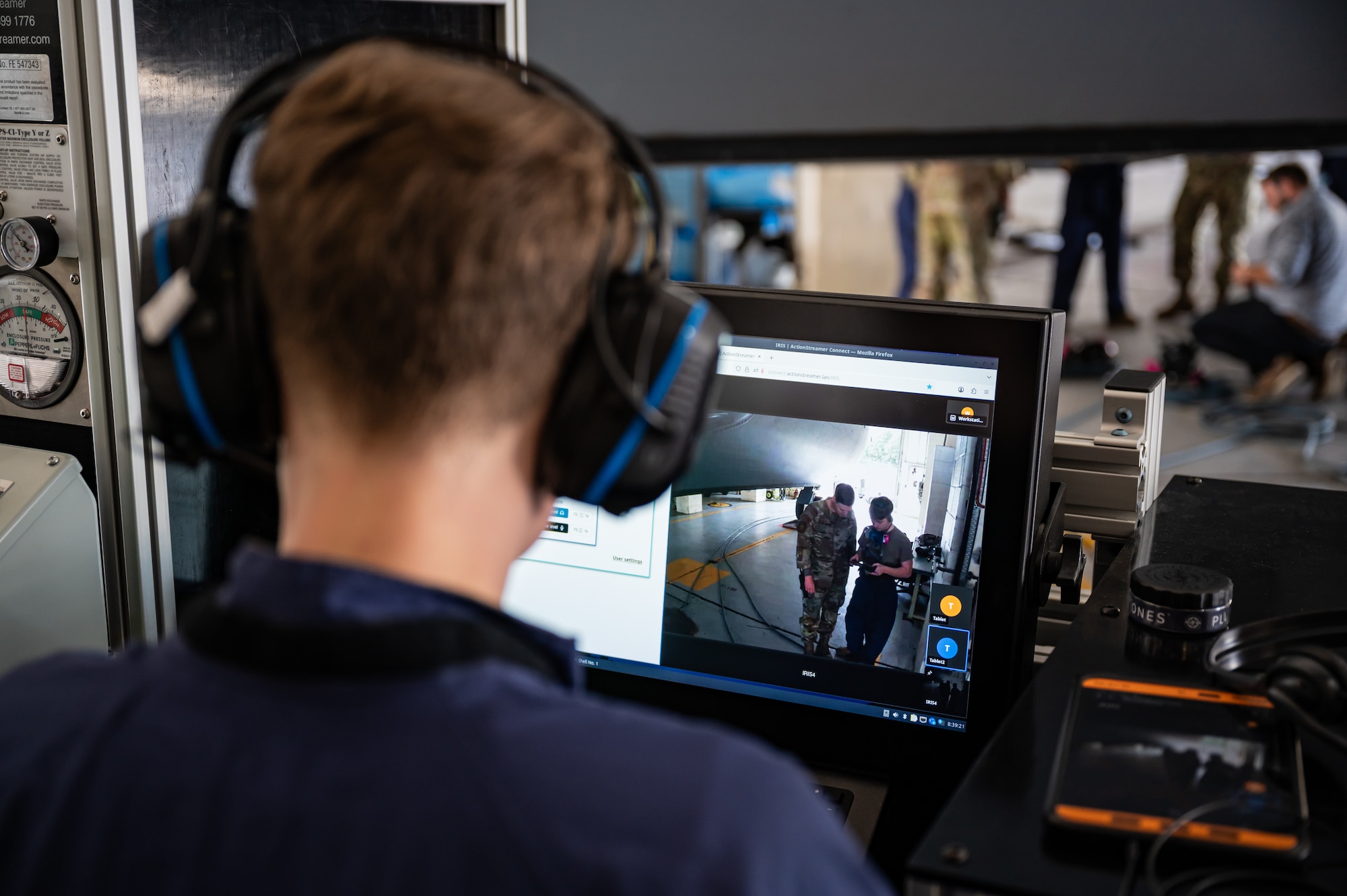 U.S. Air Force Senior Airman Hunter Holland, 100th Maintenance Squadron, monitors the live-feed from another Airman using the Integrated Respirator Information System at RAF Mildenhall, England, Sept. 2, 2025.