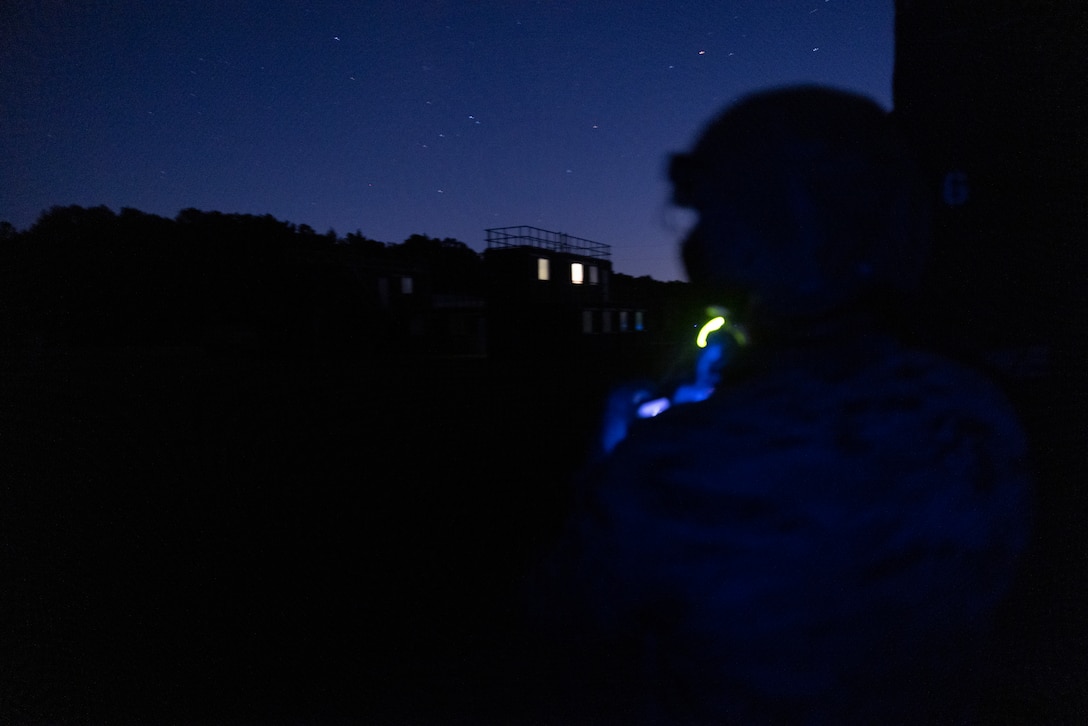 U.S. Marine Corps Gunnery Sgt. Jamie Gill, a Marine with 3rd Force Reconnaissance Company, 4th Marine Division, watches as Marines and partner nation forces participate in a nighttime raid during exercise UNITAS 2025 Marine Corps Base Camp Lejeune, North Carolina, Sept. 23, 2025. UNITAS, which is Latin for “unity,” was conceived in 1959 and has taken place annually since first conducted in 1960. This year marks the 66th iteration of the world’s longest running annual multinational maritime exercise. (U.S. Marine Corps photo by Lance Cpl. Payton Goodrich)