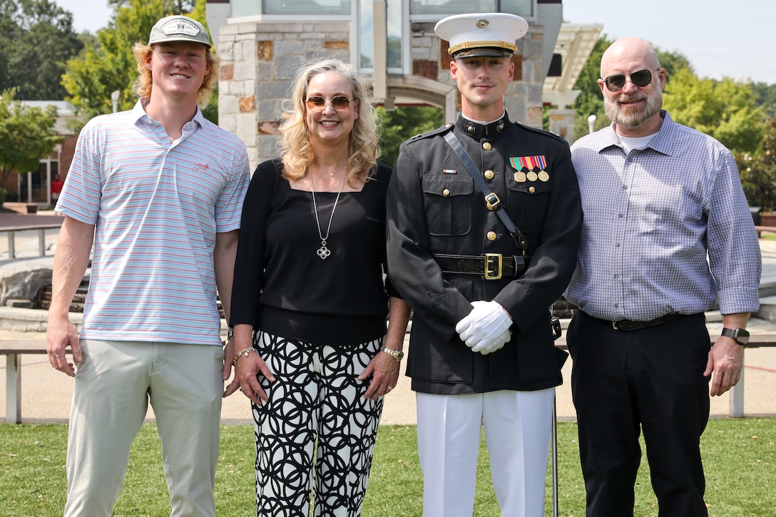 U.S. Marine Corps Capt. Ford Higgins, platoon commander, United States Marine Corps Silent Drill Platoon, Marine Barracks Washington, poses for a photo with his family following a performance at Greater Atlanta Christian High School during Marine Week Atlanta in Norcross, Ga., Aug. 28, 2025. The year 2025 marks the 250th anniversary of the United States Marine Corps, a milestone that highlights the legacy, transformation and enduring spirit of the Corps since 1775. Throughout the year, Marines across the globe will commemorate this anniversary by honoring the service and sacrifice of those who served before them and by remaining faithful to the motto Semper Fidelis. (U.S. Marine Corps photo by Cpl. Christopher Prelle)