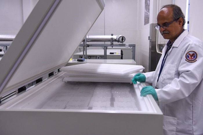 Image of a person working on a machine.