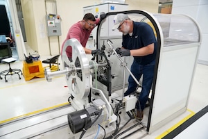 Men working on propeller blade balance