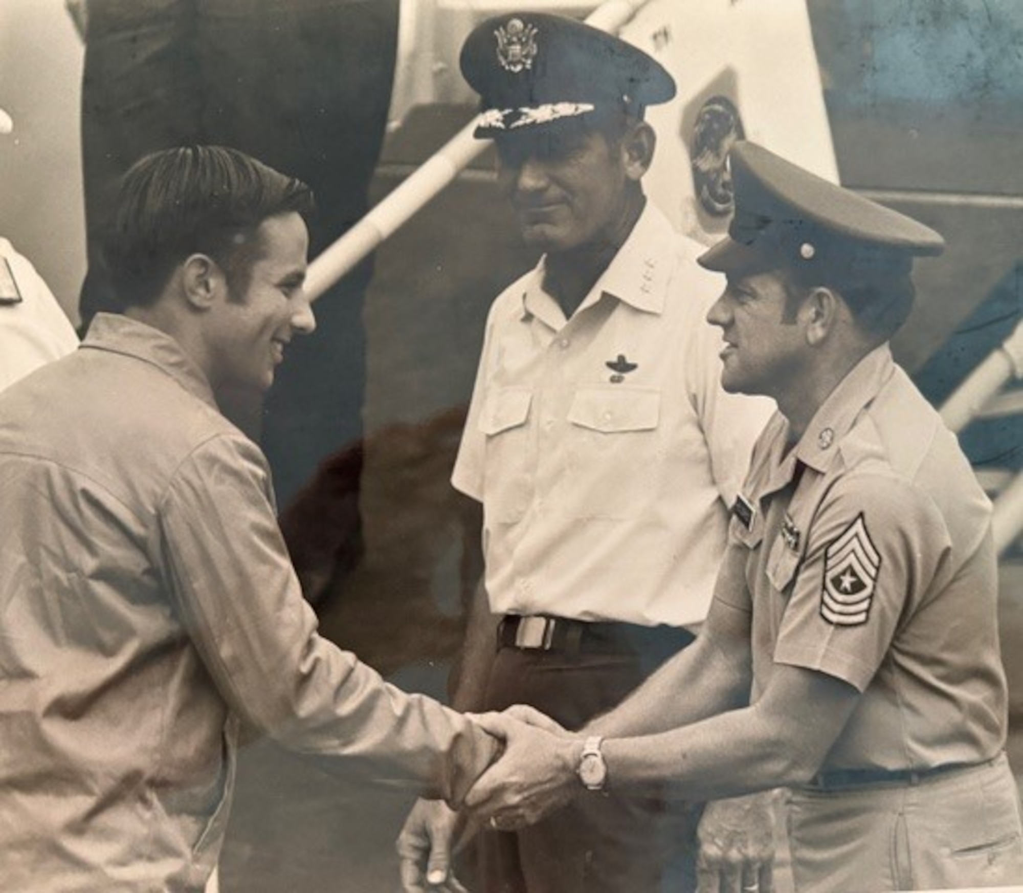 Photo of Capt. Jackson shaking hands with other military members