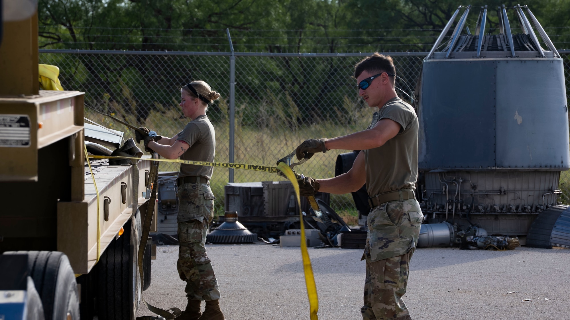 Airmen from the 7th Logistics Readiness Squadron unstrap a UH-1 Iroquois helicopter at the 436th Training Squadron Aircraft Mishap Investigation Course Crash Lab at Dyess Air Force Base, Texas, September 23, 2025. The UH-1 was the 436th TRS’s newest edition to the crash lab, enabling the squadron to bolster learning materials. (U.S. Air Force photo by Staff Sgt. Tyrell Hall)